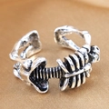 Close-up of vintage silver skeleton rib cage ring with adjustable open band detail - Retro Skull Ribs