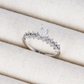 Detailed close-up of a silver crown ring with a pear-shaped zircon on a jewelry display - Clear Pear Main Diamond White Gold Style (Style 14 White Gold)