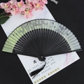 Elegant green floral folding fan with plum blossom pattern and black decorative tassel - Butterfly Cherry Green Surface Black Handle