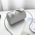 Chic light gray barrel crossbody bag with litchi texture and elegant bow zipper detail - Gray