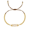 Bohemian handmade gold beaded bracelet with a white woven rectangle and gold heart motif - Woven Gold Heart White Base Gold Beads (MI-B23030601F)