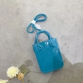 Flat lay of a bright blue PVC jelly handbag with top handles and a long shoulder strap - Peacock Blue