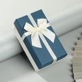 Rectangular navy and cream gift box with woven texture and a white ribbon bow - Blue Lid White Base / Medium