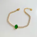 Gold stainless steel tennis bracelet with sparkling zircons and green emerald gemstone - Gold/Oval Green Zircon (SBK376)