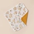 Floral cotton baby bib with pompom trim and snap button on beige background - Mixed Flowers And Turmeric