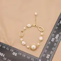 Bracelet asymétrique en perles baroques et chaîne plaquée or au design vintage - Bracelet Métallique Irrégulier