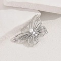 Close-up of a silver butterfly hair clip with hollow wings and inlaid pearls on stone - Silver Large Butterfly