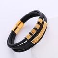 Detail of men's multilayer black braided leather bracelet with golden steel Greek key charm - Gold