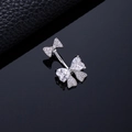Silver butterfly navel ring featuring heart-shaped zircons on a leather background - Heart Butterfly Silver