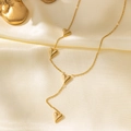 18K gold-plated heart pendant necklace featuring multiple small 3D hearts on a silk background - Heart Tassel Necklace / Gold