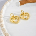 Detail shot of two gold hollow heart pendants with hanging loops on a white tray - Hollow Double Heart Gold