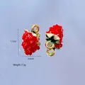 Detail of strawberry alloy pendant with red enamel finish and small green leaf detail - Strawberry