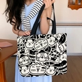 Large canvas tote bag with black and white cartoon puppy print and wide shoulder strap - Movie Cat