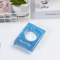 Detail of 3-inch mini photo album with blue starry ocean cover and round window cutout - Lake Blue Round