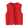 Close-up of red cable knit vest featuring three front bow ties and textured weave - Red