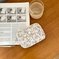 White quilted storage pouch with black botanical floral print and snap closure - Outline Floral