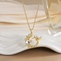Detailed shot of hummingbird and flower pendant with round opal-like stone and zircons - FN0122 Hummingbird Floral Stone Disc