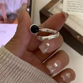 Vintage S925 sterling silver open ring with a black round gemstone on a model hand - Round Black Zirconia Open Style (JZ0327)