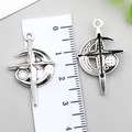 Pair of silver hollow star and crescent pendants showing 3.5cm measurement on ruler - Four-Pointed Star Moon Cross (22339) / 1 Piece (30x19mm) / Antique Silver