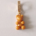 Orange translucent gummy bear pendant with gold rhinestone clasp on a white background - Caramel Coffee