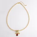 Gold mesh tube necklace featuring a detailed plane, suitcase, and globe charms for travelers - Travel Set A (Airplane/Suitcase/Earth/Passport)