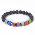 Detailed macro shot of square chakra stones and black lava beads on elastic yoga bracelet - Lava Stone