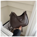 Detail of dark brown PU leather crescent bag with embossed heart and silver hardware - Brown