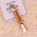 Brown multi-color ballpoint pen with cute bear topper on pink starry tulle background - Brown Dinosaur