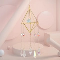 Detail of golden geometric crystal suncatcher with rainbow prisms and faceted sphere - Style A