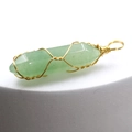 Macro view of green hexagonal crystal pendant with gold wire wrap on white background - Green Aventurine