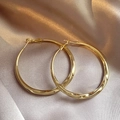 Elegant gold twisted hoop earrings featuring 925 silver needles on champagne silk background - Gold Twisted Wave Mirror Large Hoop Earrings