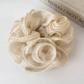 Detailed view of cream-colored organza floral scrunchie with delicate woven edges - Beige
