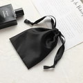 Elegant black faux silk drawstring pouch for cosmetics and luxury gift packaging - Black