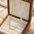 Golden butterfly necklace with light blue resin charms displayed in a wooden gift box - Mint Green Butterfly