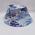 Detailed view of the tropical leaf and geometric polka dot print on a bucket hat - Blue White Black Leaves