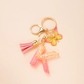 Pink resin letter K keychain with glitter, butterfly charm and pink tassel accessory - Letter K