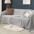 Gray waffle weave sofa cover throw with tassel edges on a three-seater sofa - Grey