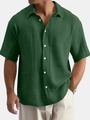 Close-up of men's dark green cotton short sleeve shirt showing crinkle texture and lapel - Green