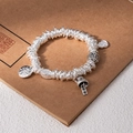 Silver bead bracelet with traditional pendants including a bell and flower charm - L525-2 Good Luck Every Year