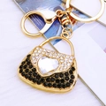 Golden purse keychain with black rhinestones and a large heart-shaped crystal heart - Black Heart Handbag Keychain
