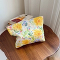 Close-up of floral cotton makeup bag featuring yellow flowers and a simple wish label - Large Yellow Flower