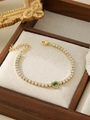 Detail view of gold tennis bracelet featuring green heart gemstone and zircon stones - Green Heart-Shaped Style