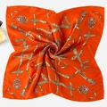 Detailed macro view of luxurious orange silk scarf with equestrian chain print pattern - Orange Bar Chain