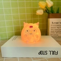Cartoon pig character night light made of soft silicone emitting a warm orange glow - Fat Kuromi