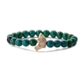 Detail of beaded bracelet with green turquoise beads and a white dolphin charm - Chrysocolla