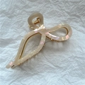Macro view of creamy white acetate hair claw with iridescent finish and gold spring - 3# Iridescent White