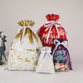 Set of four glossy Christmas drawstring gift bags in gold, red, purple, and silver foil - 20-Piece Set
