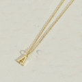 Detail view of gold letter A pendant necklace with refined link chain on stone background - Letter A(AXL2998)
