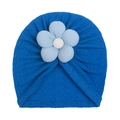 Detail of royal blue baby turban hat featuring a large light blue floral knit ornament - Sapphire Blue