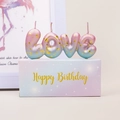 Detailed view of LOVE letter candles with pink blue gradient and gold foil in gift box - Galaxy Gradient Pink Blue LOVE